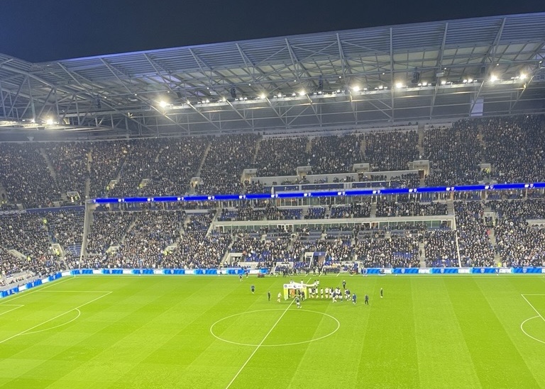 Packed stands at Hill Dickson Stadium with supporters cheering during a Premier League match.