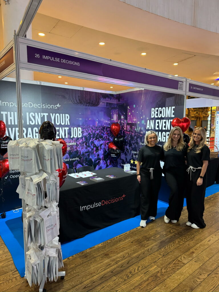 Photo of staffing team infront of stand at Manchester Job Show