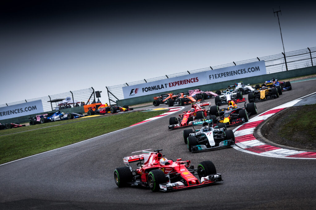 Ferrari leading a pack of Formula 1 cars through a corner at the Chinese Grand Prix.