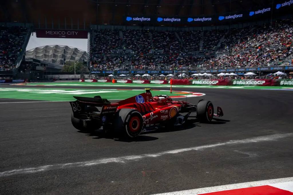 Ferrari Formula 1 car racing through the stadium section at the Mexico City Grand Prix.