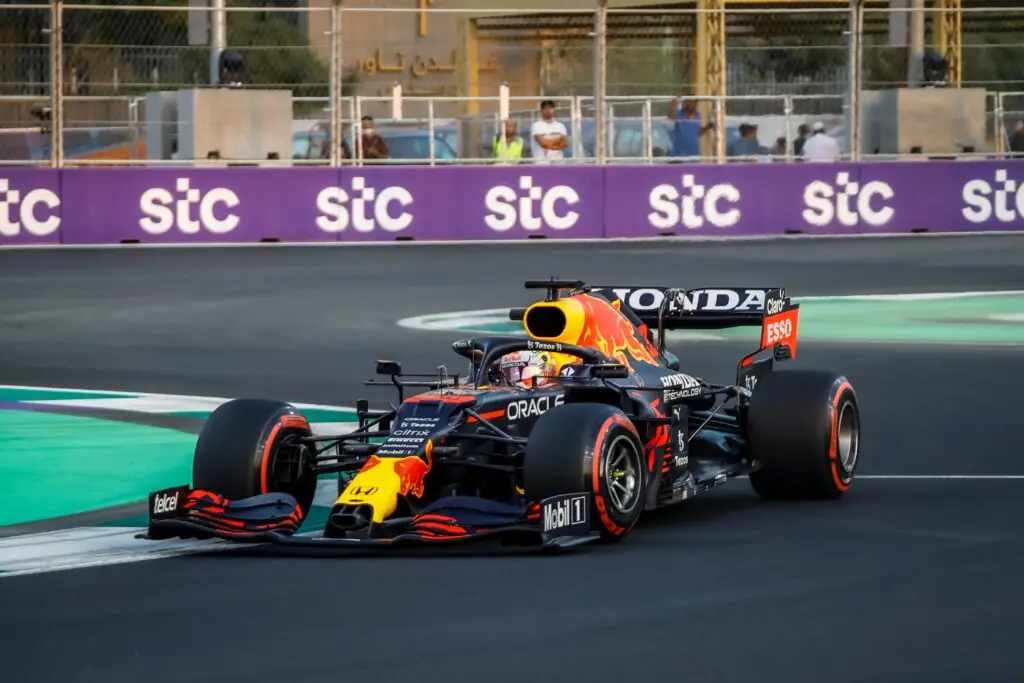 Red Bull Formula 1 car taking a corner at Jeddah Corniche Circuit.