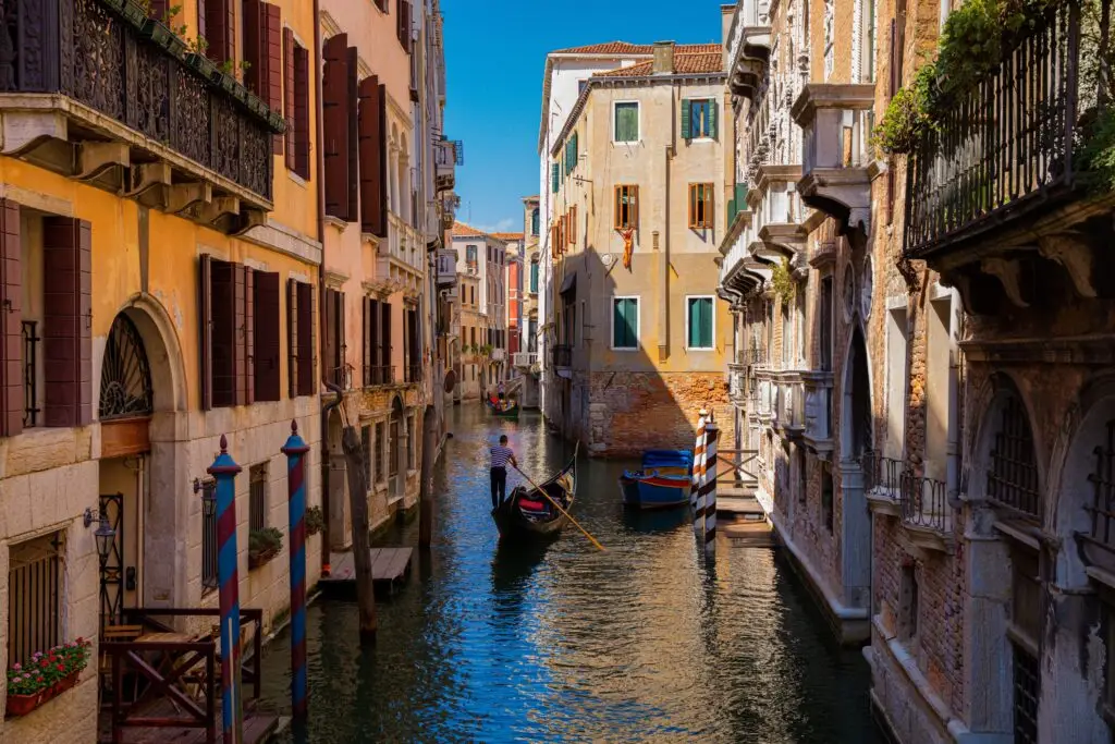 Colorful historical houses and buildings and bridges at small canals in Venice, a city in Italy