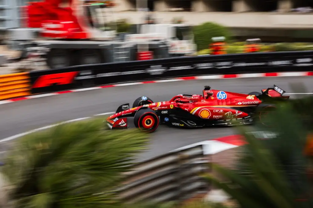 Ferrari Formula 1 car speeding through a corner on Monaco’s street circuit.