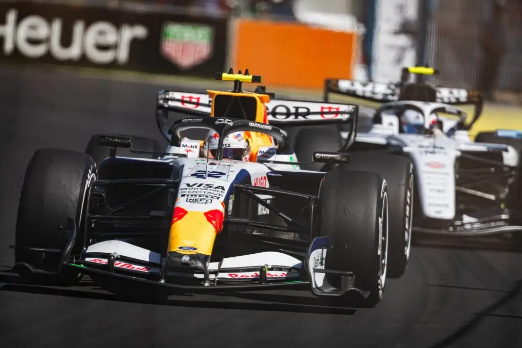 Red Bull Formula 1 car leading a Williams through a corner.
