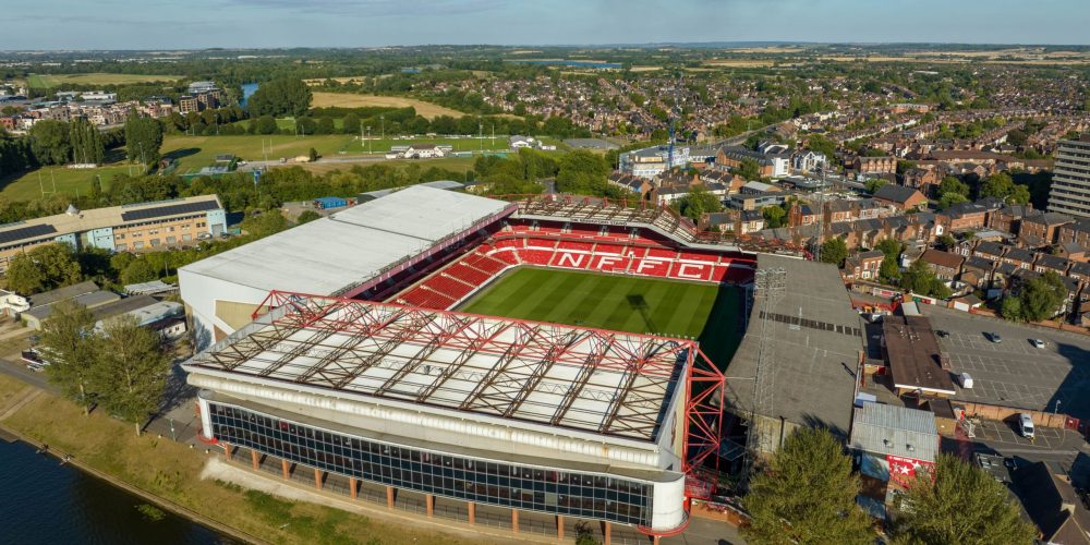 Aerial view of The City Ground showing the four stands and riverside setting.